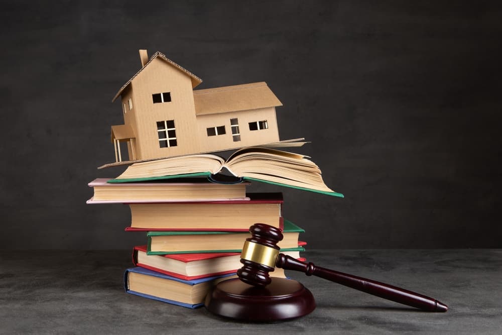 House model, gavel and books on the desk, Real property law concept